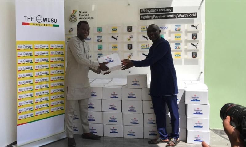 Samuel Owusu presents sanitizers to GFA