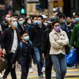 Pedestrians wearing face masks cross a road during a Lunar New Year of the Rat public holiday in Hong Kong on January 27, 2020, as a preventative measure following a coronavirus outbreak which began in the Chinese city of Wuhan