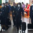 Airline staff wear protective face masks at Santiago international airport, Chile, on March 14, 2020.