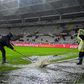 Groundsmen clear water from the pitch before the Torino v Inter Milan Serie A game in Turin