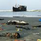 Belongings of Rohingya refugees rest on the shore as their boat remains anchored off Teknaf in Bangladesh on Thursday