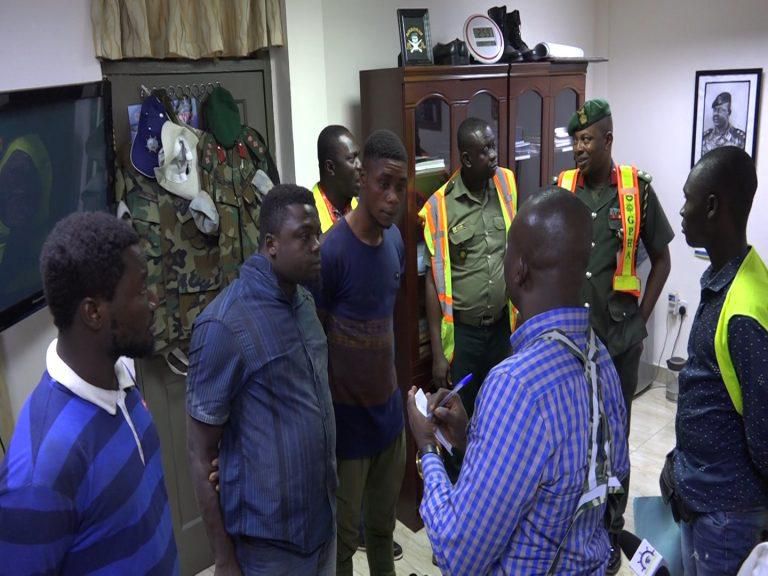 The three Nigerians are in the grip of the Police