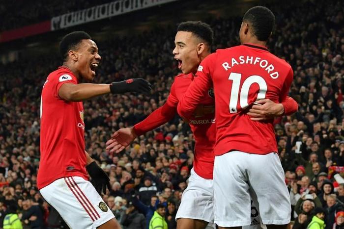 Manchester United goal-scorers Mason Greenwood, Anthony Martial and Marcus Rashford celebrate against Newcastle