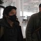 Wall Street Journal reporters Philip Wen (left) and Josh Chin walk through Beijing Capital Airport on their way out of China