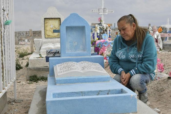 Maria Guadalupe Guereca beside the tomb of her son Sergio Hernandez who was killed in a cross-border shooting by a US border patrol agent