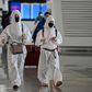 Passengers in protective gear walk through Tianhe Airport after it was reopened in Wuhan in China's central Hubei province