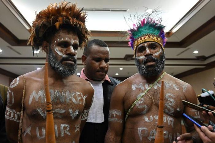 Papuan activists Ambrosius Mulait (left) and Dano Anes Tabuni speak to journalists during their trial in Jakarta