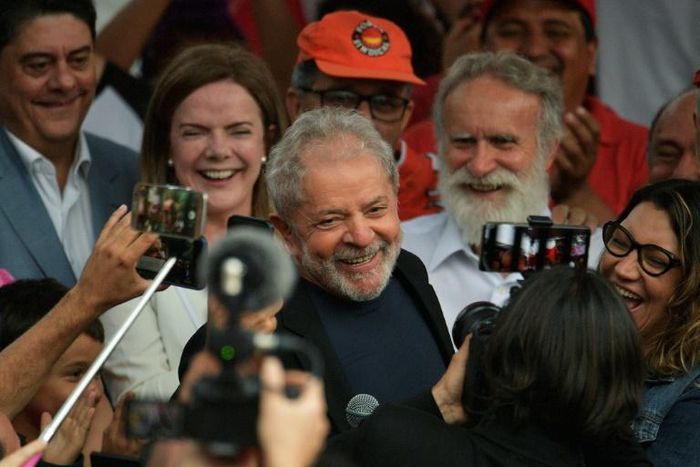 Former Brazilian president Luiz Inacio Lula da Silva smiles next to his girlfriend after leaving the federal police headquarters in Curitiba, where he was serving a sentence for corruption and money laundering