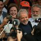 Former Brazilian president Luiz Inacio Lula da Silva smiles next to his girlfriend after leaving the federal police headquarters in Curitiba, where he was serving a sentence for corruption and money laundering