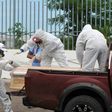 Workers wrap with plastic a coffin with the remains of a person who died from the coronavirus, COVID-19 in Guayaquil, Ecuador