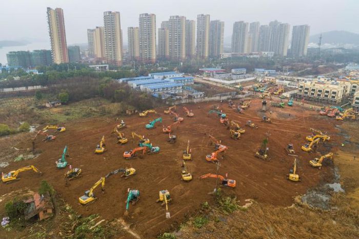 Workers toiled day and night amid a forest of earthmovers and trucks carting goods around the site, southwest of the centre of the city of 11 million