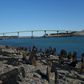 Cars cross over the International Bridge from the US state of Maine (left) on the US-Canada border, which the US is closing to "non-essential" traffic