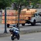 Coffins are seen stacked high on a pick-up truck and trailer as it passes a hospital in Guayaquil, Ecuador