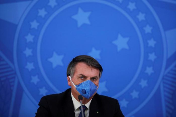Brazilian president Jair Bolsonaro, shown here during a press conference on the virus on March 20, has run afoul of social media networks recently for spreading misinformation about the pandemic
