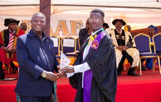 Alhassan Mohammed (R) receiving his certificate at the graduation ceremony