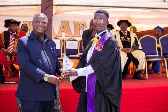 Alhassan Mohammed (R) receiving his certificate at the graduation ceremony