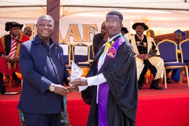 Alhassan Mohammed (R) receiving his certificate at the graduation ceremony