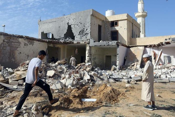 Libyans check the site of an air strike that killed three children in October, 2019 on the outskirts of the capital Tripoli as forces of eastern strongman Khalifa Haftar battled forces loyal to the UN-recognised Government of National Accord (GNA)