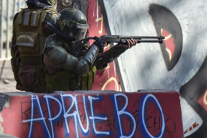 Riot police in Chile take aim at protesters during anti-government demonstrations in Santiago on February 21