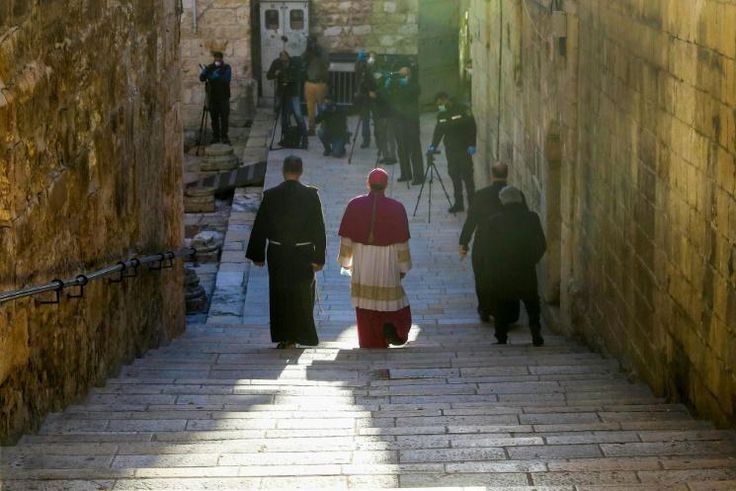 Archbishop Pierbattista Pizzaballa (C), Apostolic Administrator of the Latin Patriarchate of Jerusalem, makes his way through a largely empty Holy City to the Church of the Holy Sepulchre for the Easter Sunday service