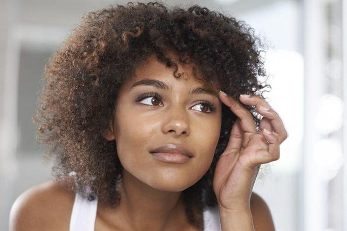 Woman applying vaseline on her eyebrows