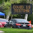 A police officer mans the entrance to a coronavirus (COVID-19) testing center in Hansen Dam Park in Pacoima, California