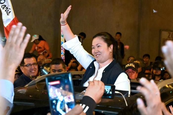 Peruvian politician Keiko Fujimori waves to supporters as she is released from prison in Lima on November 29, 2019