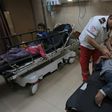 A Palestinian medic tends to surviving children from the Abu Malhous family which lost eight members to an Israeli strike on their Gaza home that the military says targeted an Islamic Jihad commander