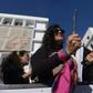 A member of the Tunisian "EnaZeda", (Me too) movement bangs a pot at a rally against sexual harassment in Tunis on November 30, 2019