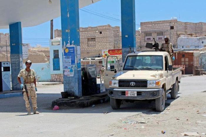 Yemeni pro-government fighters gather at a petrol station on April 10 in the coastal town of Shihr, in the southern Hadramawt province where the country's first case of coronavirus was reported
