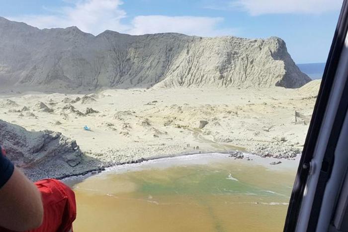 This handout photo taken on December 9, 2019 from the Auckland Rescue Helicopter Trust shows the ash and debris covering White Island volcano a day after it erupted off the coast of New Zealand's North Island