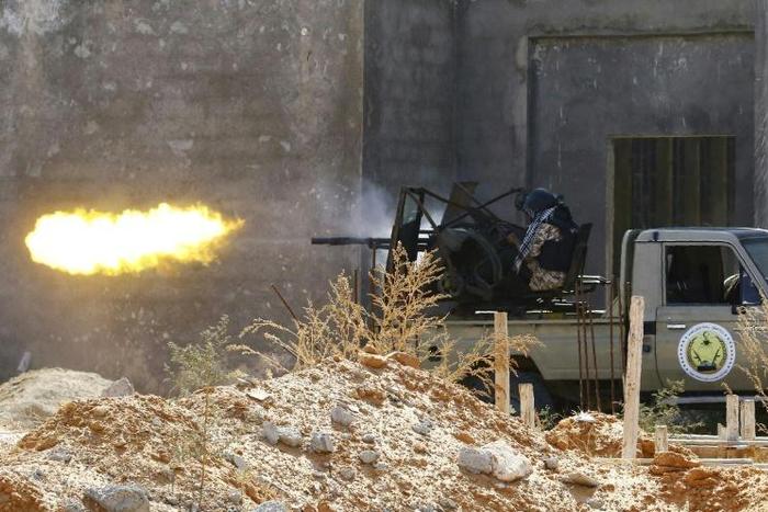 A fighter loyal to Libyan Government of National Accord (GNA)opens fire in clashes with forces loyal to strongman Khalifa Haftar in suburban Tripoli