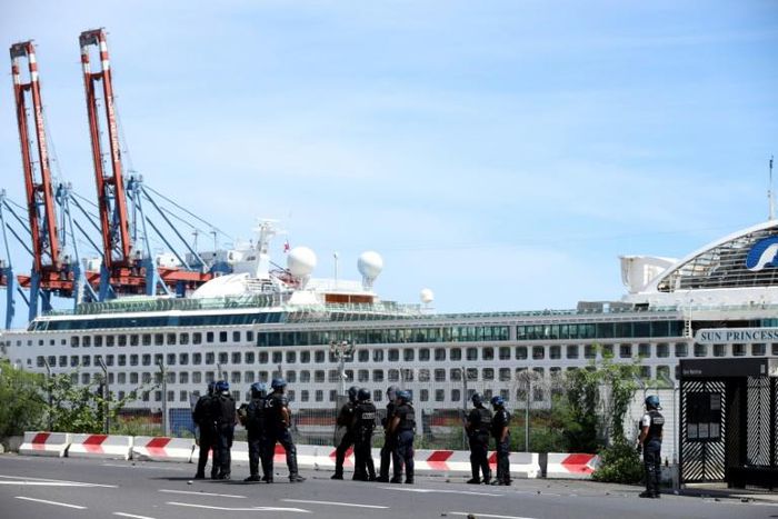 French police officers face demonstrators in Le Port on March 1, 2020, as people protest passengers from the Sun Princess cruise ship on the Indian Ocean island of La Reunion disembarking without having temperatures checked; The incident came hours aft...