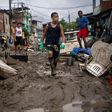 Children walk in the mud following heavy rains during the weekend, in Realengo neighborhood, in the suburbs of Rio de Janeiro, Brazil, on March 2, 2020