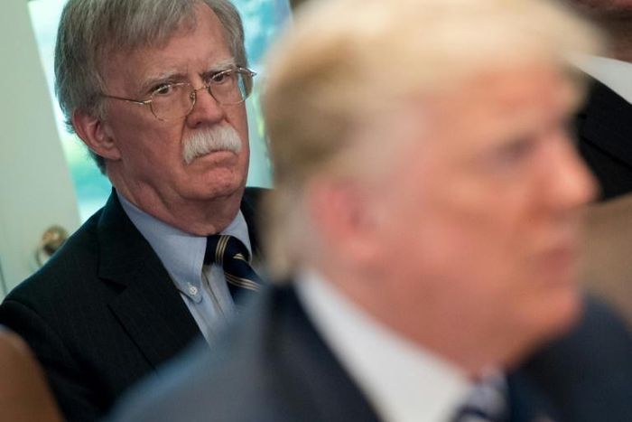 Trump's denial came after The New York Times reported that his former national security advisor John Bolton (L) says in his upcoming book that the president tied Ukraine aid to an investigation of his rivals