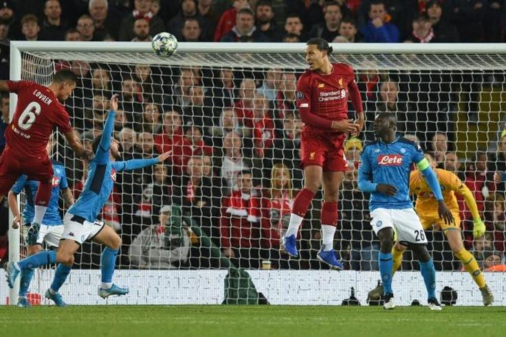 Dejan Lovren (left) rises highest to head home Liverpool's equaliser against Napoli