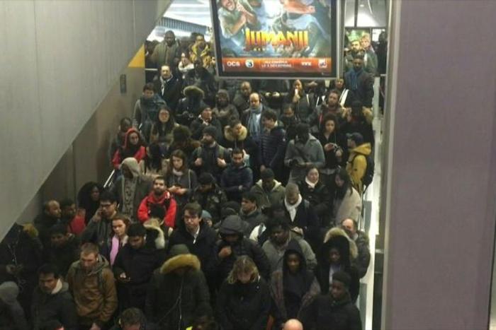 Commuters rush to board overcrowded trains to the Paris suburbs during rush hour
