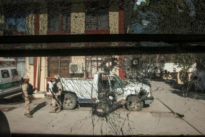 Soldiers stand guard in front of the city hall in Villa Union, Mexico on December 2