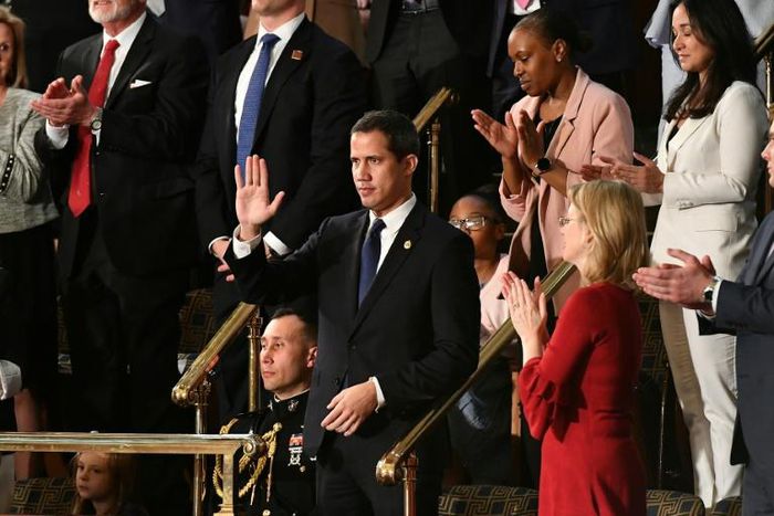 Venezuelan opposition leader Juan Guaido (C) waves as he is acknowledged by US President Donald Trump during his the State of the Union address at the US Capitol on February 4, 2020.
