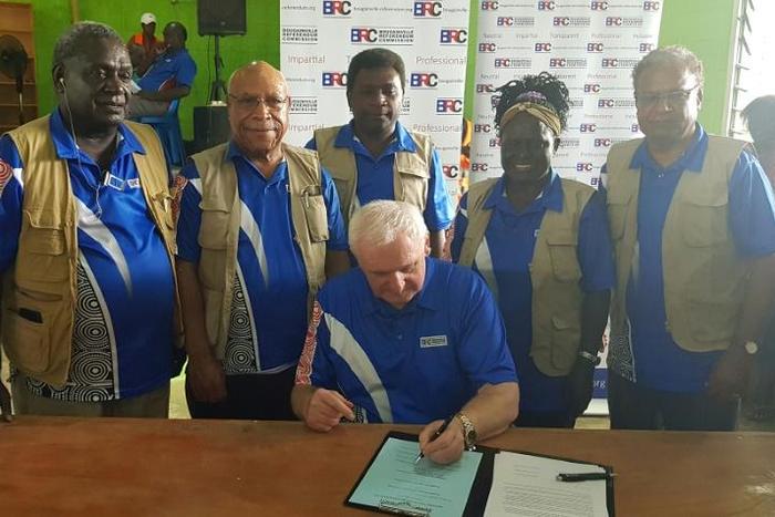 Bougainville Referendum Commission chairman Bertie Ahern (C) says the result sent 'shockwaves' through PNG's government