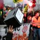 Multiple funds have been launched to help compensate striking workers. The picture shows a marcher holding up a contribution box