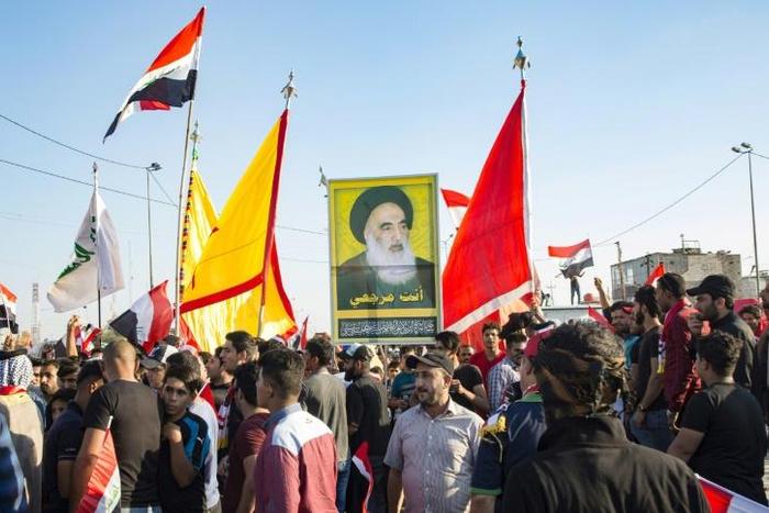 Demonstrators in Iraq's main southern city of Basra hold aloft a portrait of Shiite spiritual leader Grand Ayatollah Ali Sistani, who has increasingly backed their cause