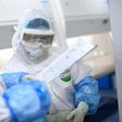 A lab technician works on samples being tested in Wuhan