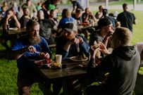 Mooney (second left) refuels at the camp lobster bake.