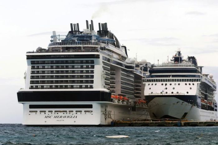 The MSC Merviglia cruise ship (L) lying off Cozumel, Mexico, on February 27, 2020