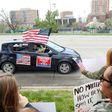 A supporter of President Donald Trump in Kansas City, Missouri waves an American flag during a protest against restrictions imposed on businesses to fight the COVID-19 pandemic