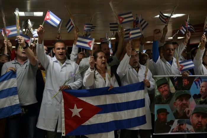 Doctors wait for fellow medical personnel returning from Bolivia at the Jose Marti International airport in Havana on November 16, 2019