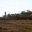Israeli tanks stand guard close to the armistice line with Syria on the strategic Golan Heights