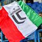 A young Juventus supporter waves the Italian flag.