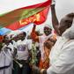 Joy: Eritrean women hold aloft the national flag in July 2018 to welcome passengers arriving from Ethiopia, a key step in the two rivals' path to peace